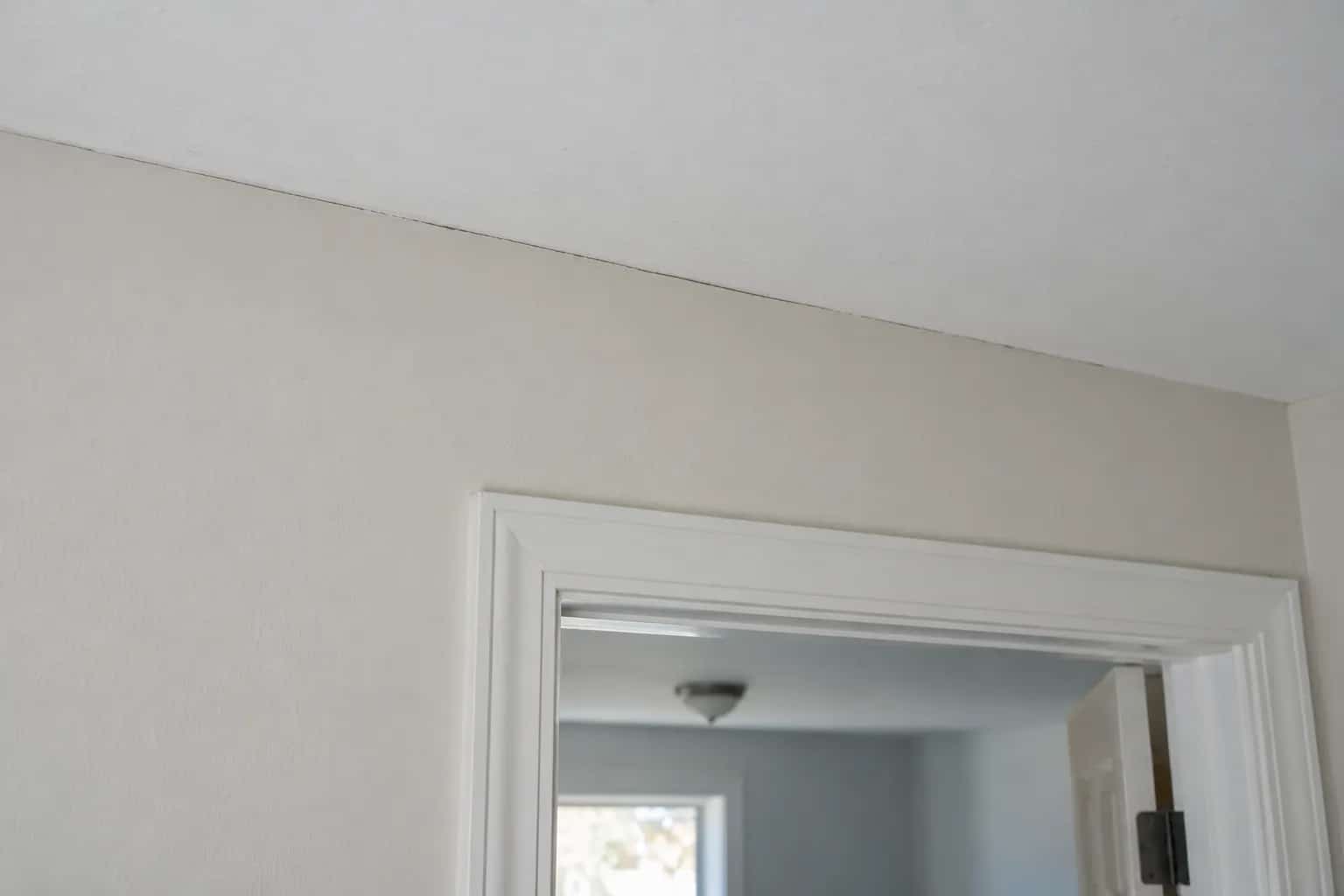 Fine separation along a ceiling-to-wall joint above a doorway