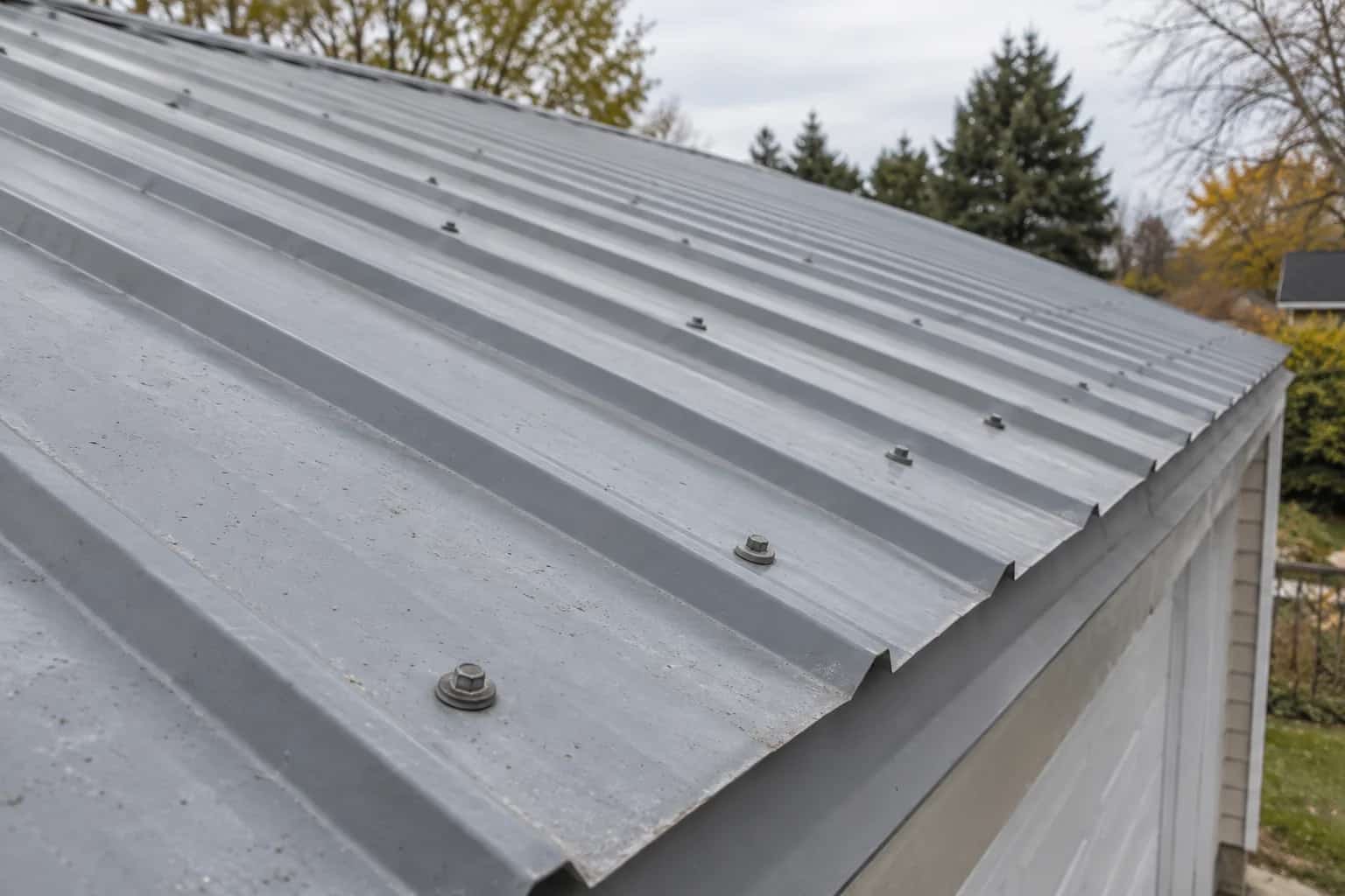 Grey ribbed metal roof with visible screw heads and washers
