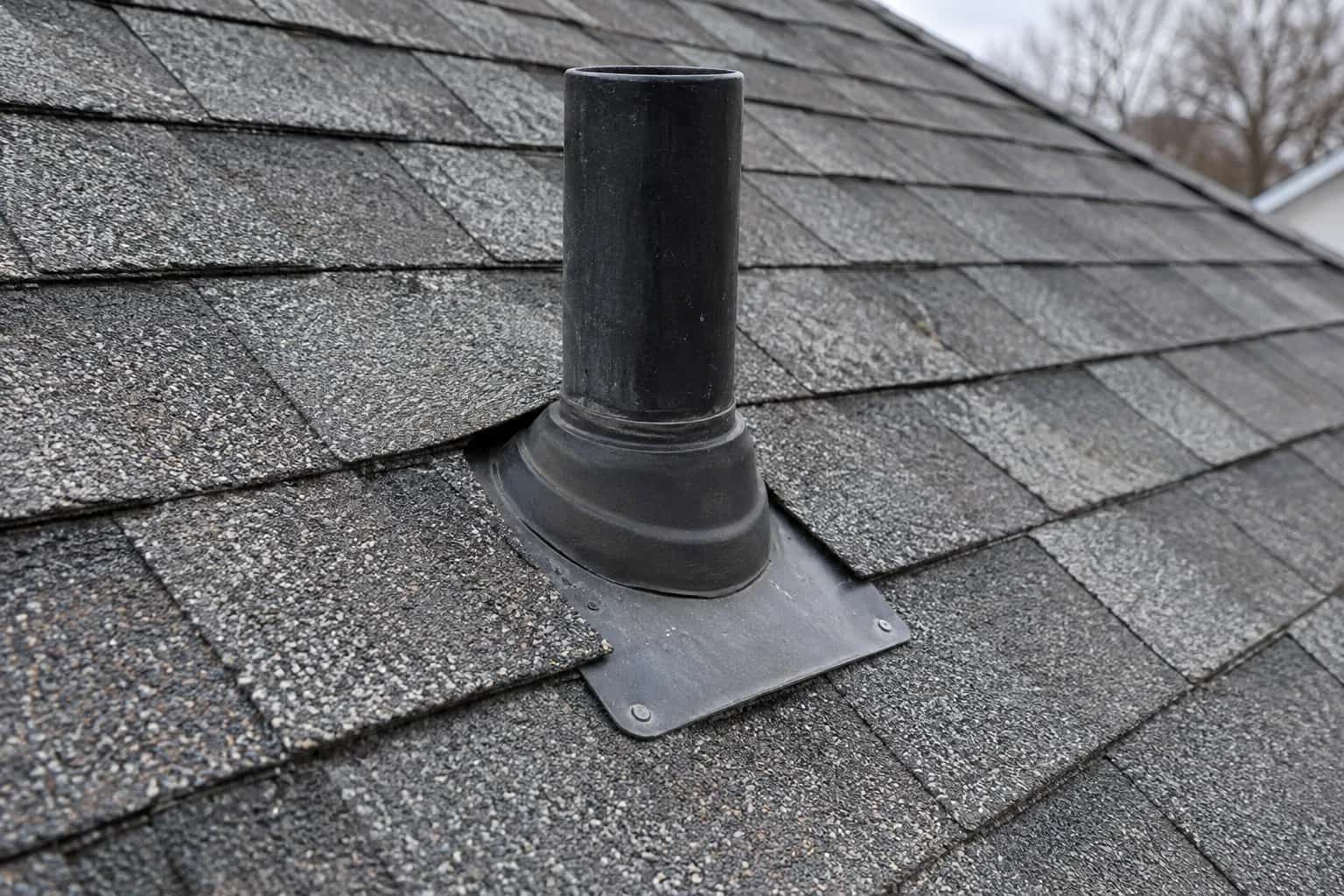 Black pipe and rubber boot over shingle roof