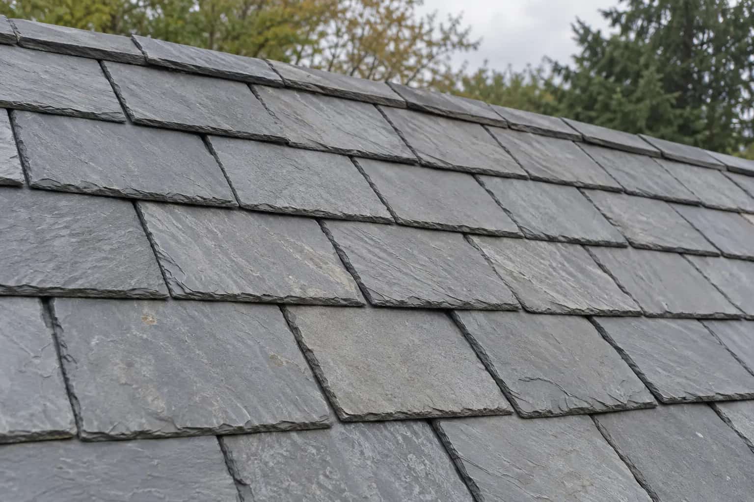 Grey slate-like roof tiles in overlapping courses with layered stone edges
