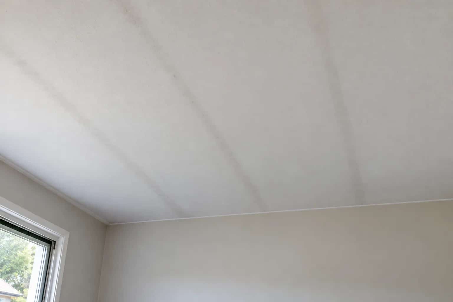 Faint parallel grey lines across a white ceiling.